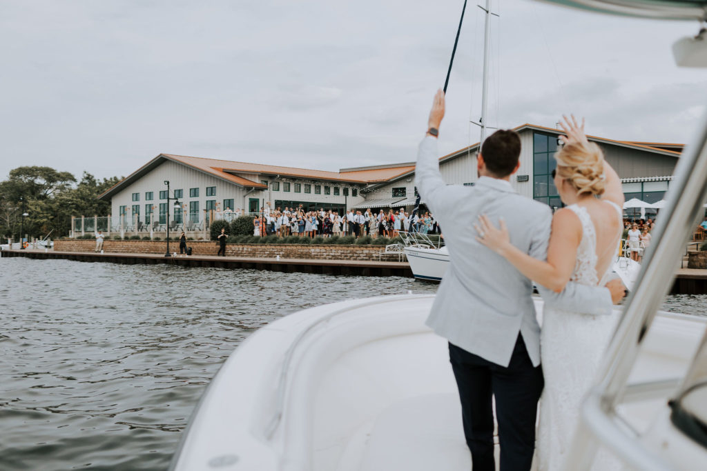 Bride and Groom arriving by boat to Boatwerks Restaurant
