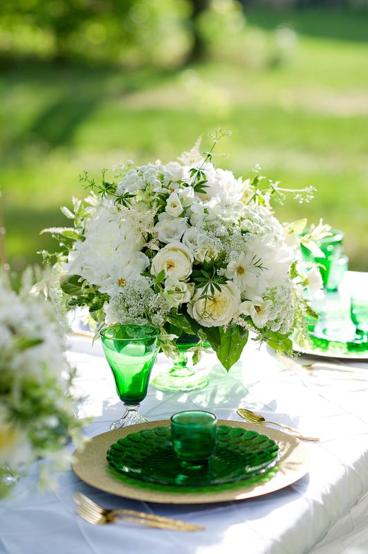 Outdoor reception table with white floral arrangement